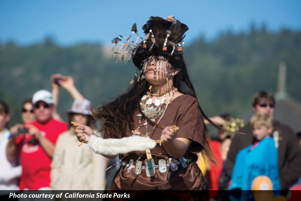 Native American young person dancing in cultural garb