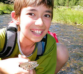 boy holding small fish