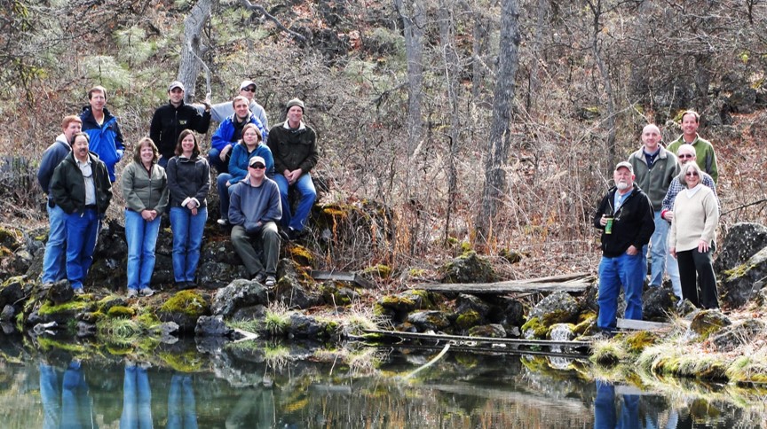 team members gathered on river bank
