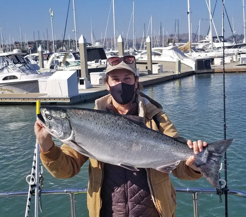 scientist holding chinook salmon