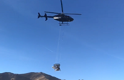 Helicopter carries seeding equipment