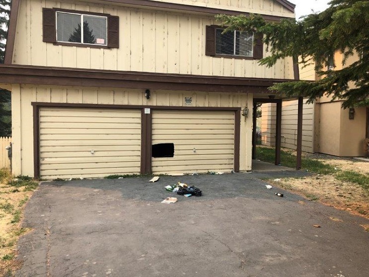 A garage door in South Lake Tahoe has a hole in it -- the result of marauding black bears during evacuation as a result of the Caldor Fire.