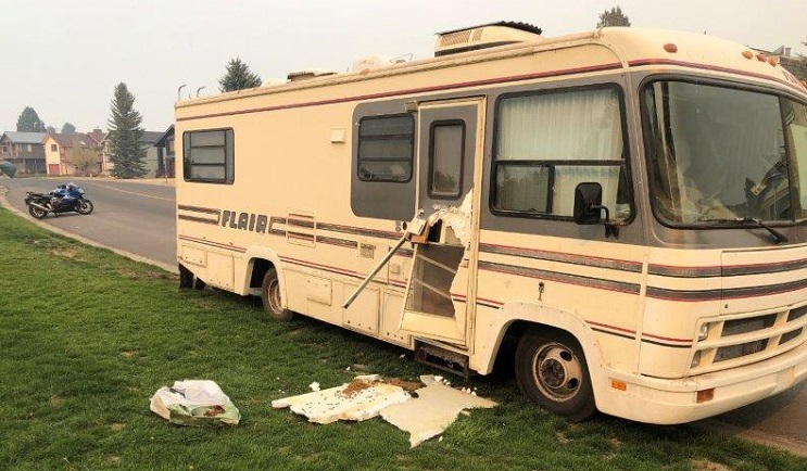 A recreational vehicle with a broken door shows the after-effects of a bear break-in during evacuation in South Lake Tahoe as a result of the Caldor Fire.