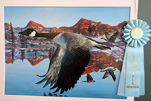 Painting with light blue ribbon of Canada geese flying over water with snowy mountains in background.