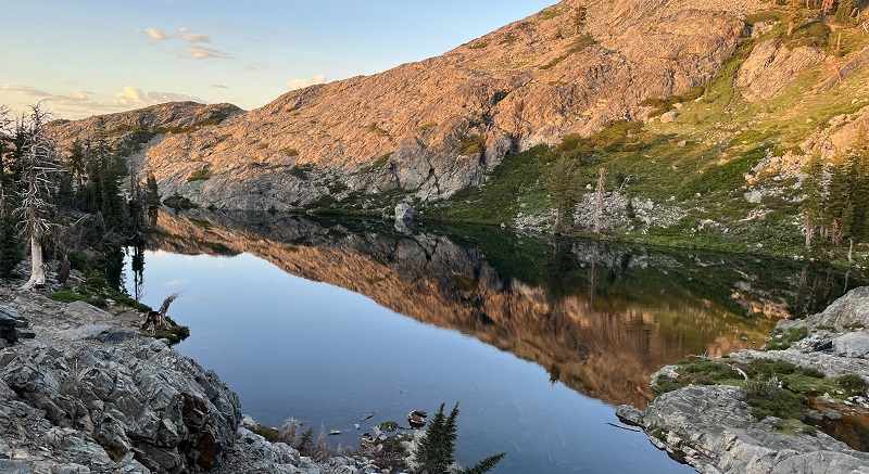 A high Sierra lake surrounded by granite cliffs.