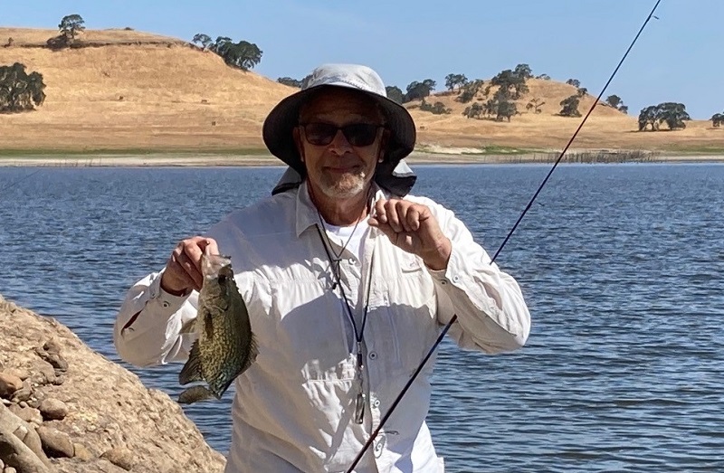 An angler shows off a black crappie caught a Central Valley reservoir.