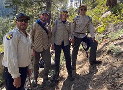 Farhat Bajjaliya stands with three colleagues, fly rods in hand, as they prepare to survey the North Fork Mokelumne River.