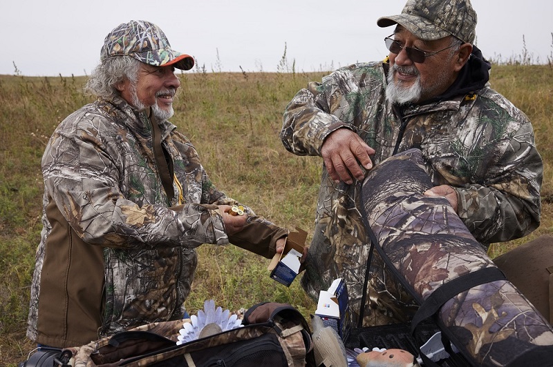 Two hunters load their gear as they prepare to go dove hunting.