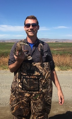 Ian holds a wild duck trapped at the Grizzly Island Wildlife Area so the bird can be outfitted with a radio transmitter to better understand migration patterns and habitat usage.