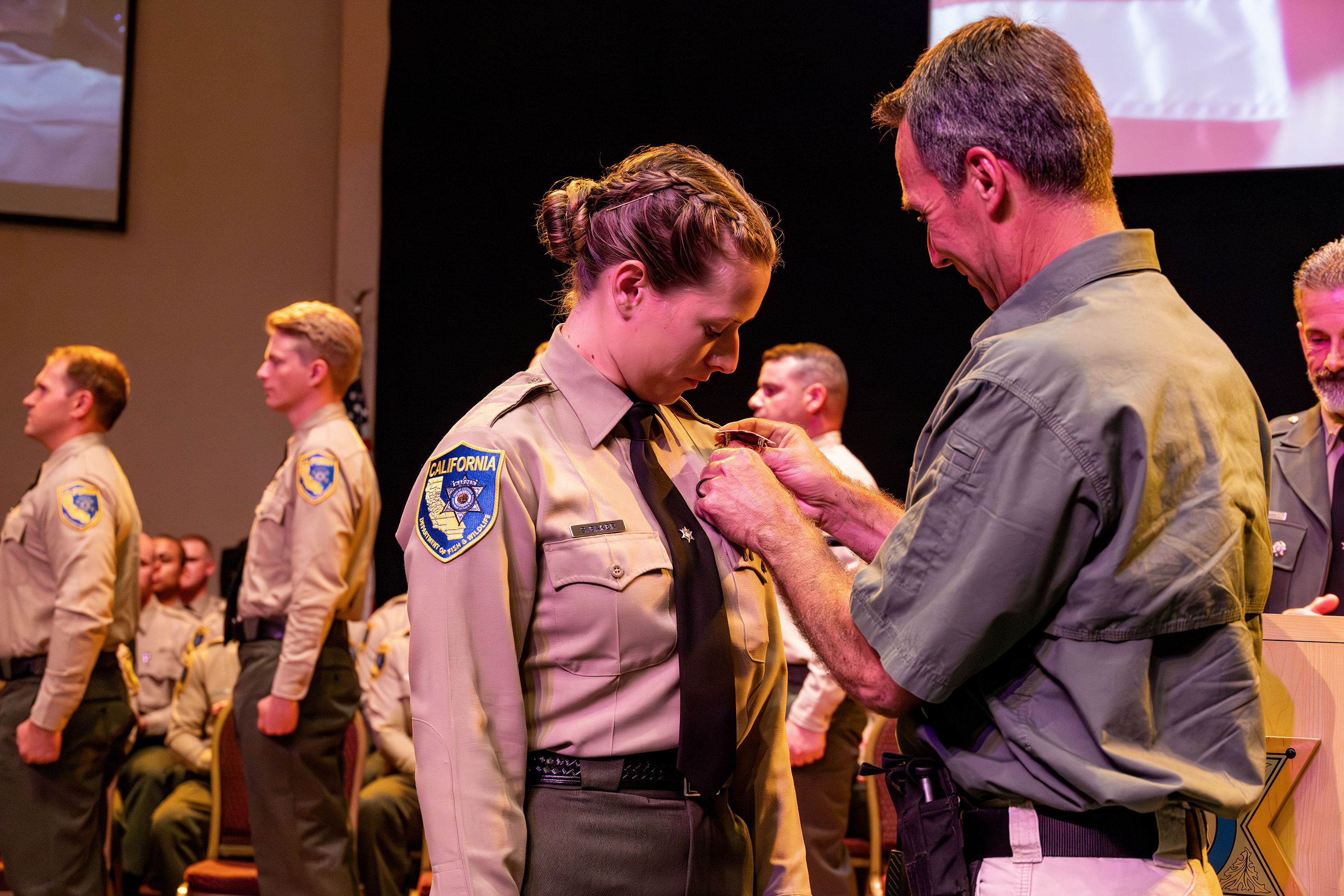 Wildlife Officer receiving official pin from father.