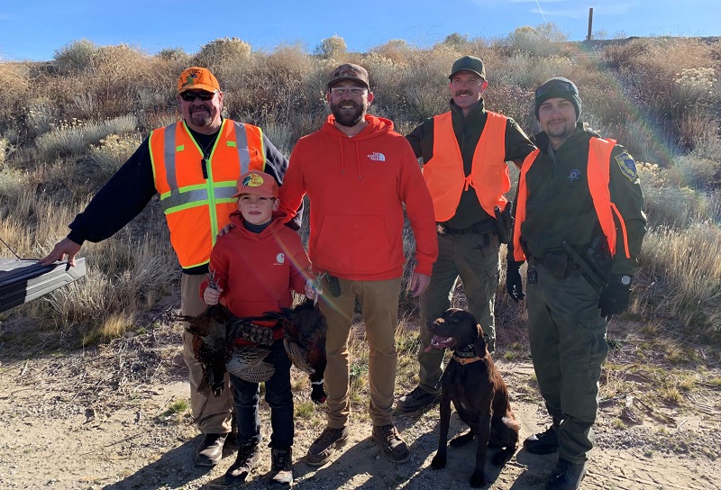 Participants and volunteers pose after a successful apprentice pheasant hunt in Southern California.