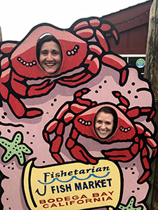Two scientists with smiling faces in a crab cut out