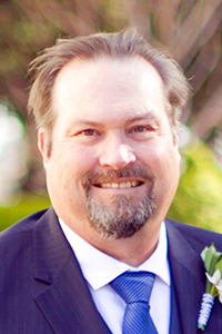head shot of a middle-aged white man with brown hair and a goatee