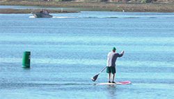 person on a paddleboard on Newport Bay, Pacific Ocean