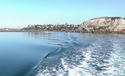 blue ocean water in the Newport Bay with mountains and blue sky