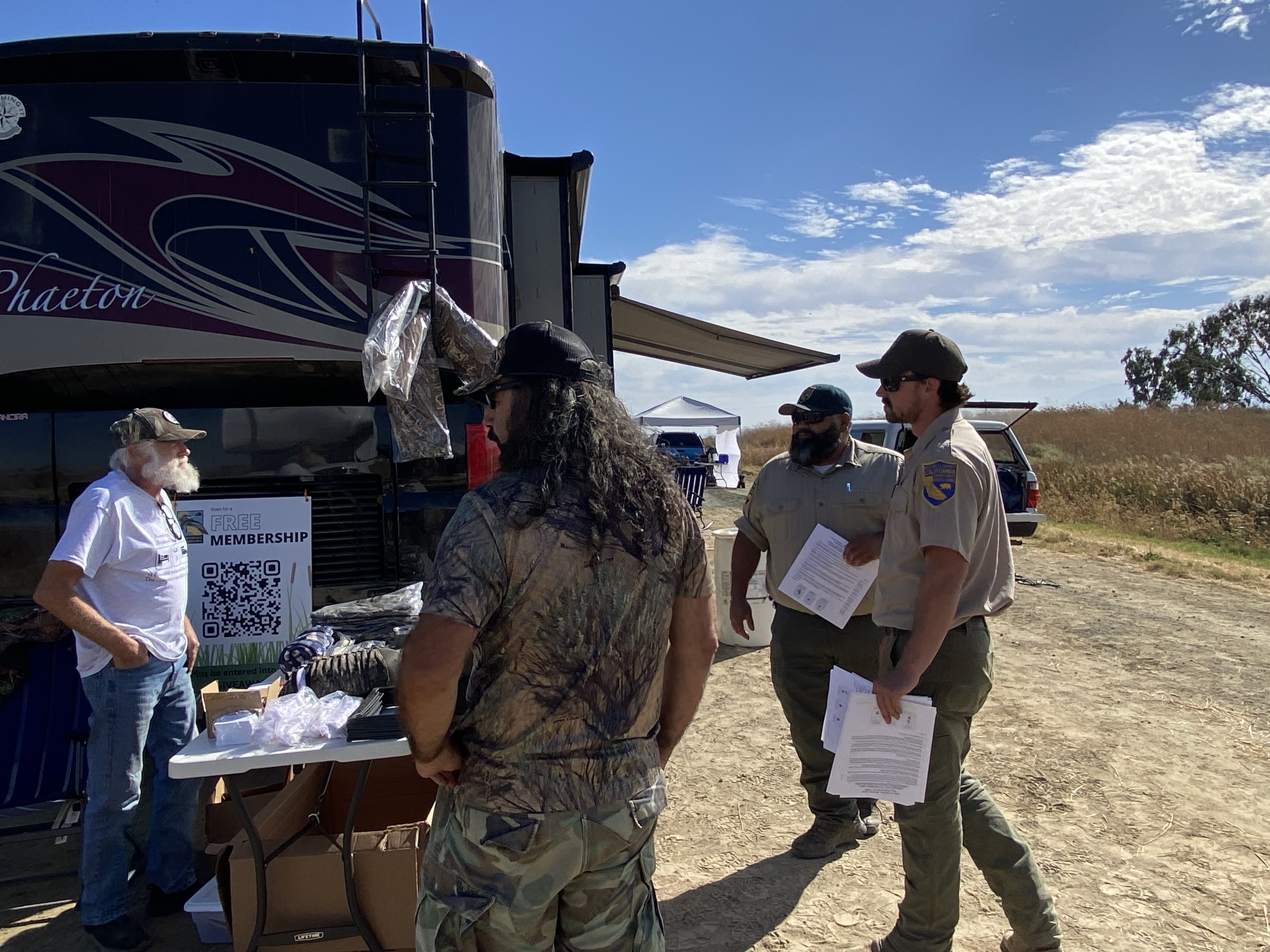 CDFW at Grizzly Island Wildlife Area in Solano County talk with waterfowl hunters lined up and waiting for season opener.