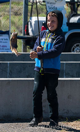 Boy holding a fish - Photo by DFW David Hunter