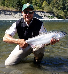 Picture of Farhat Bajjaliya holding a Chinook Salmon.