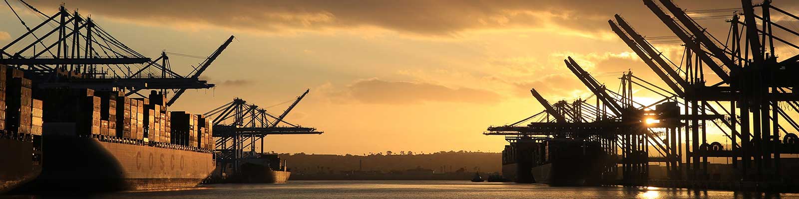 cargo ship at port during sunset