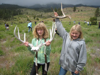 Two students display deer sheds they found on Nevada’s winter range. (DFG photo by Sara Holm)