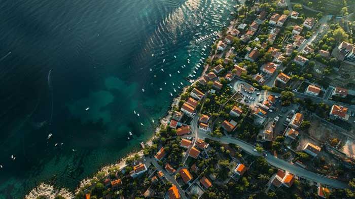 aerial view of small coastal towns with boats dotting the water